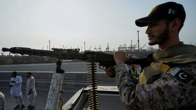 A paramilitary soldier stands guard on a vehicle at a road near Karachi port on May 9, 2025. (AP)