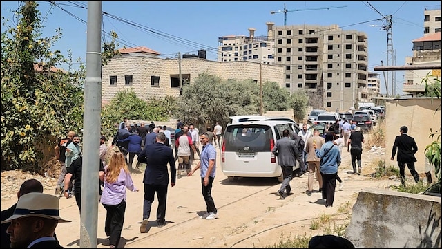 Members of a diplomatic delegation from the European Union leave in a rush after shots were fired near the Jenin camp in West Bank. (AFP)