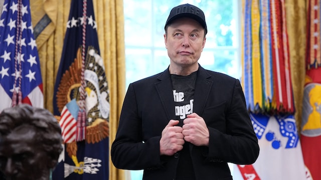 Tesla CEO Elon Musk listens as US President Donald Trump speaks to reporters in the Oval Office of the White House on May 30. (Getty Images via AFP)
