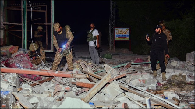 Pakistan Army soldiers examine a building damaged by a suspected Indian missile attack near Muzaffarabad, PoK. (PTI)