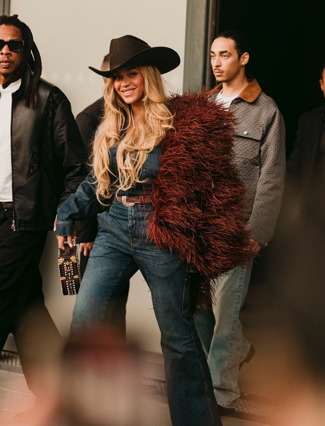 Beyonce nodded to her Grammy-winning Cowboy Carter album in dark-wash jeans and a matching denim shirt. She added a brown fuzzy coat draped over one shoulder and completed the look with a cowboy hat and platform heels. (Image: Instagram) Beyonce nodded to her Grammy-winning Cowboy Carter album in dark-wash jeans and a matching denim shirt. She added a brown fuzzy coat draped over one shoulder and completed the look with a cowboy hat and platform heels. (Image: Instagram)