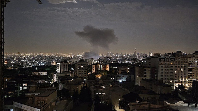 A photo released by Iran's Revolutionary Guard Corps (IRGC) official Sepah News Telegram channel on June 13 shows smoke billowing from a site reportedly targeted by an Israeli strike in Tehran early on Friday. (AFP)