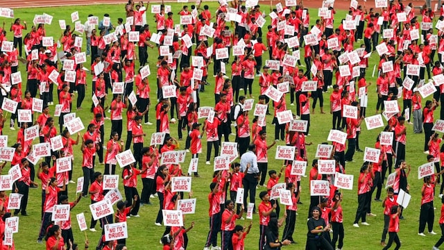  Children participate in a mega zumba dance event organised by the state government at Chandrasekharan Nair Stadium in Thiruvananthapuram. (PTI) 