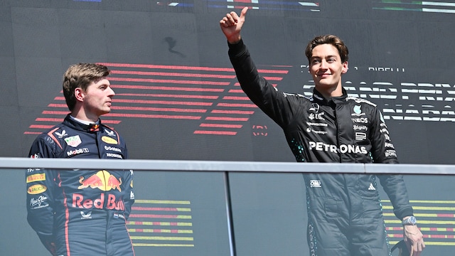 George Russell (right) celebrates after his win as second-place driver Max Verstappen watches. (AP Photo)