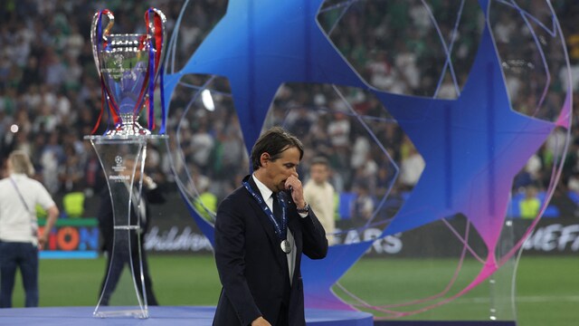 Inter's Simone Inzaghi walking past the UCL trophy he lost out on (AFP)