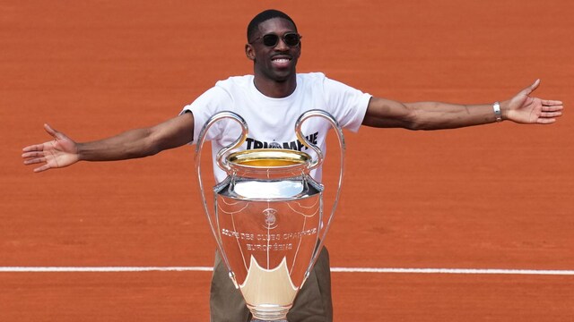 PSG's soccer player Ousmane Dembele presents the Champions League trophy during the French Tennis Open at the Roland-Garros stadium in Paris, Monday, June 2, 2025. (AP Photo/Christophe Ena)


