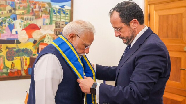 Prime Minister Narendra Modi being felicitated with Cyprus' highest honour 'Grand Cross of the Order of Makarios III' by President Nikos Christodoulides, in Cyprus. (PTI)