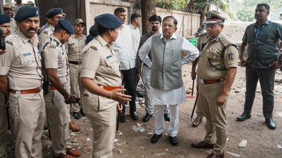 Karnataka home minister G Parameshwara with senior police officials during an inspection after the stampede near the Chinnaswamy Stadium that claimed 11 lives, in Bengaluru. File pic/PTI