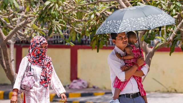 People take protection against the scorching sun on a hot summer day, in New Delhi, on Wednesday. (PTI photo)
