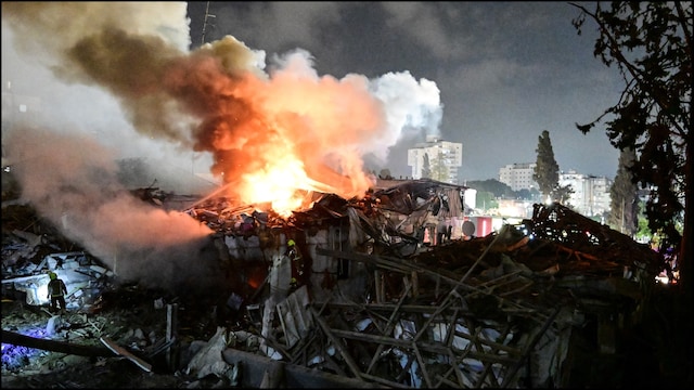 Fire Fighters work at an impact site following missile attack from Iran on Israel. (Reuters)