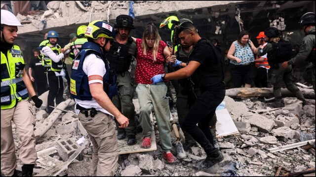 Emergency workers rescue civilians as Iran launched missiles at Israel. (Reuters)