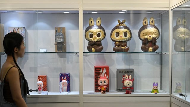 A woman visits the Yongle Auction office where limited-edition Labubu artworks are on display in Beijing. (AFP file photo)
