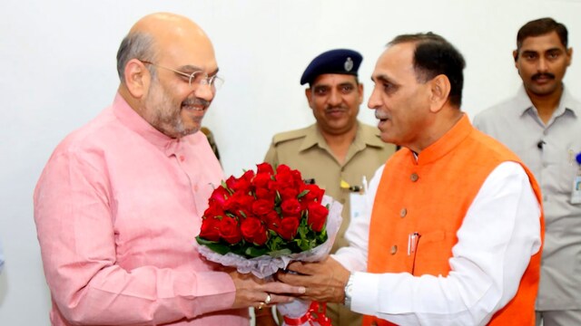 Union Home Minister Amit Shah with former Gujarat Chief Minister Vijay Rupani. (Image via X/@AmitShah)