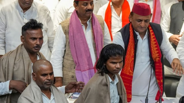 SP President Akhilesh Yadav during a meeting with 'katha vaachak' Mukut Mani Yadav, whose head was allegedly tonsured by a group of upper caste men in Etawah, and his team members, in Lucknow, on Tuesday. (PTI)