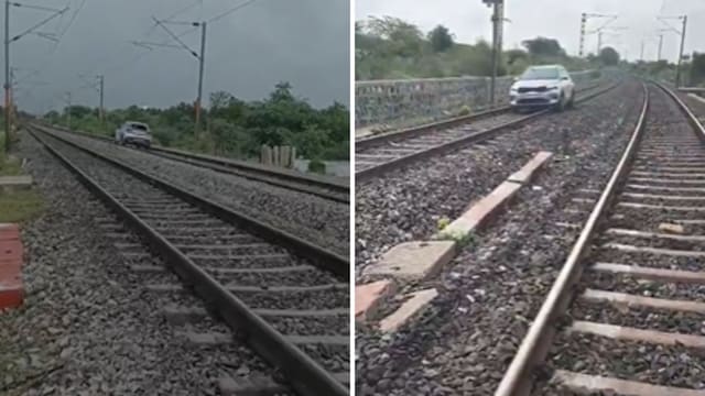 A woman was seen driving a car on a railway track in a viral video.
