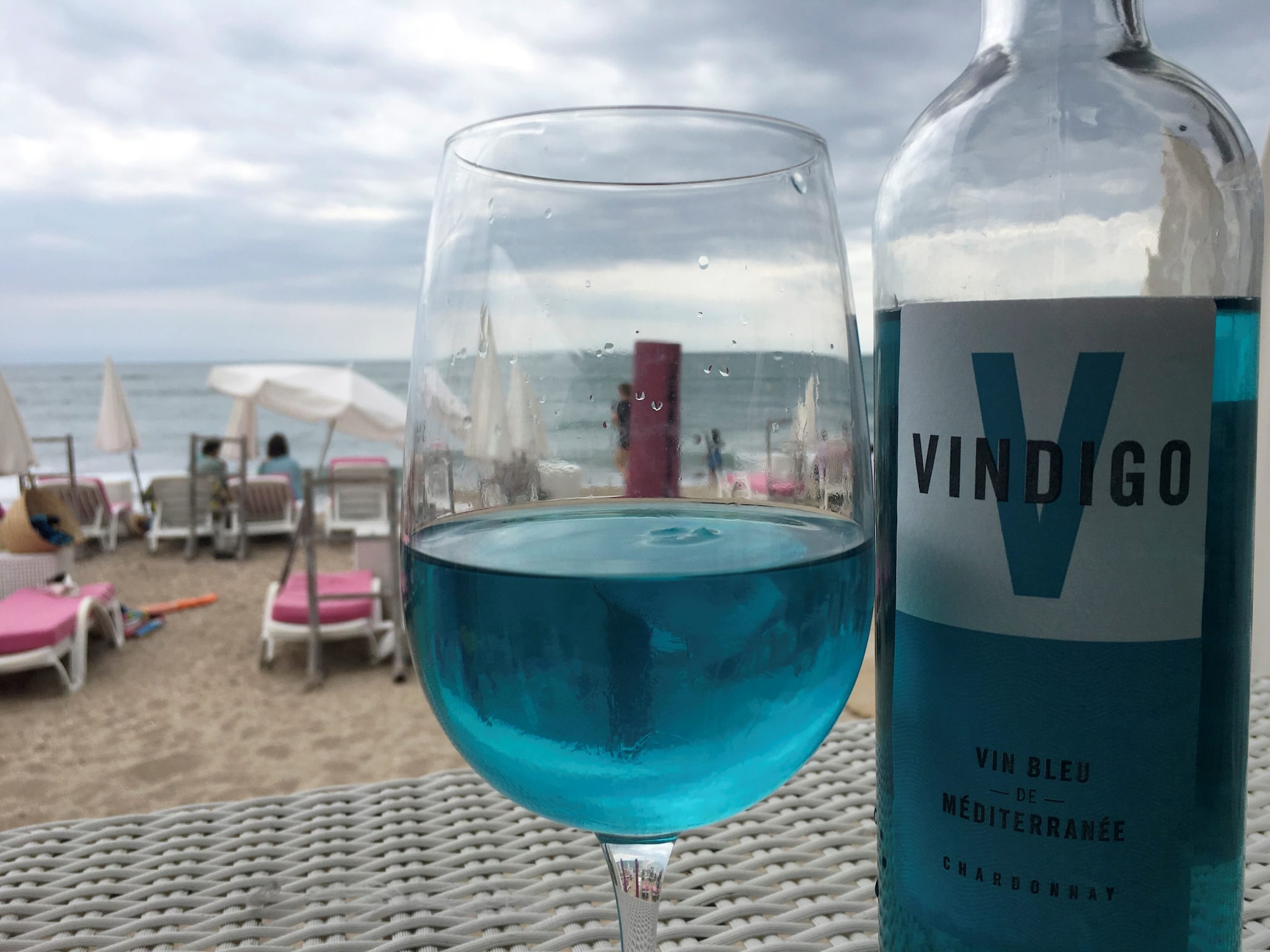 A glass of Vindigo, Mediterranean chardonnay wine, is seen at a beachfront restaurant in Sete, France. The wine is filtered through a pulp of red grape skins which contain a natural pigment, anthocyanin, and gives the wine its blue colour. (IMAGE: REUTERS) A glass of Vindigo, Mediterranean chardonnay wine, is seen at a beachfront restaurant in Sete, France. The wine is filtered through a pulp of red grape skins which contain a natural pigment, anthocyanin, and gives the wine its blue colour. (IMAGE: REUTERS)