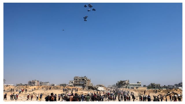 People gather as a C-130 Hercules military transport aircraft drops humanitarian aid on the northern Gaza Strip on July 27, 2025. (AFP)