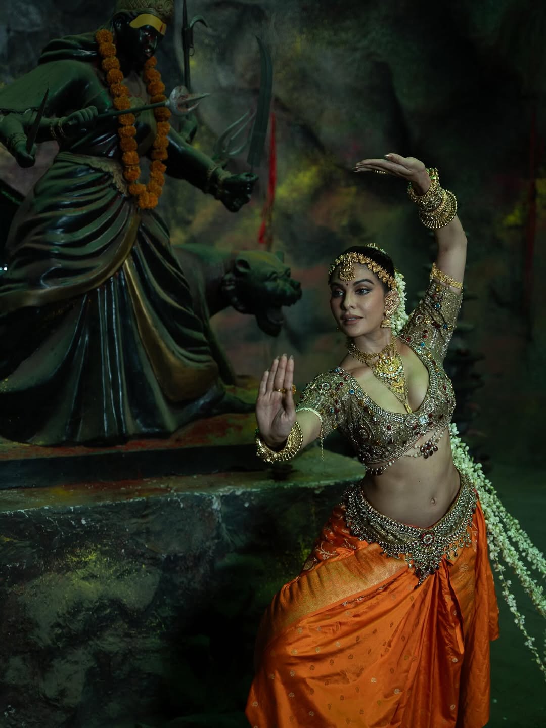 Her look was elevated with intricate jewellery, including a maang tikka, jhumkas, layered necklace, bangles, and a shimmering kamarbandh. Her hair was neatly tied into pleats. (Image: Instagram)