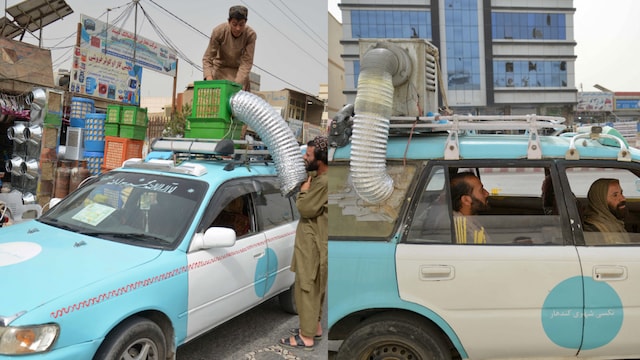 An Afghan taxi driver installs a swamp air-cooler system atop his vehicle at a market in Kandahar (AFP)