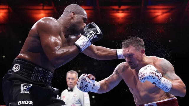 Dubois (L) was no match for Usyk's (R) pin-point jab. (Richard Pelham/Getty Images)
