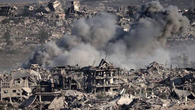 This picture taken from Israel's border with the Gaza Strip shows smoke billowing over destroyed buildings during an Israeli strike on the besieged Palestinian territory. (File/AFP)