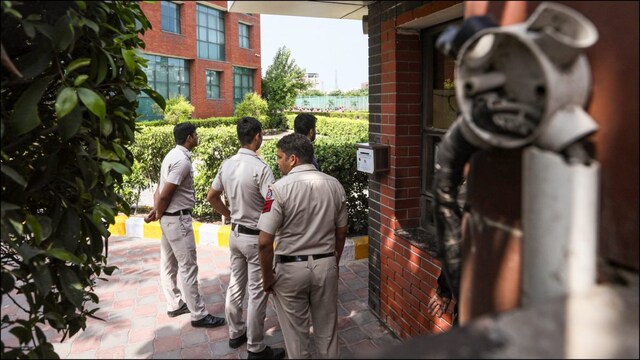 Police personnel on the premises of Delhi's The Sovereign School that received a bomb threat on Friday. (PTI)