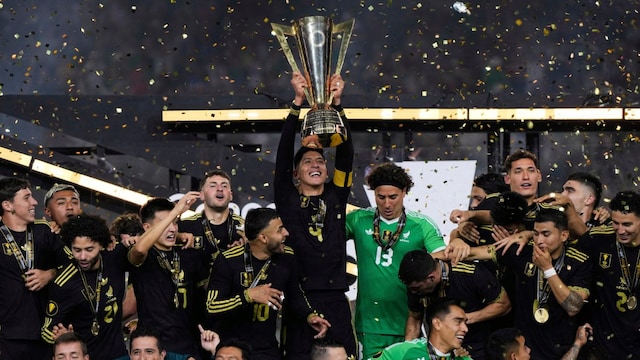 Mexico midfielder Edson Álvarez (4) holds up the trophy as players and staff celebrate after their win in the CONCACAF Gold Cup final. (AP Photo)