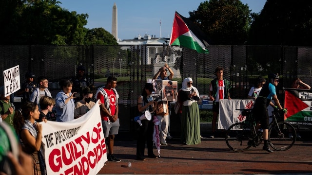 Protesters gather outside security fencing near the White House on July 7, 2025 in Washington, DC. (Getty Images via AFP)
