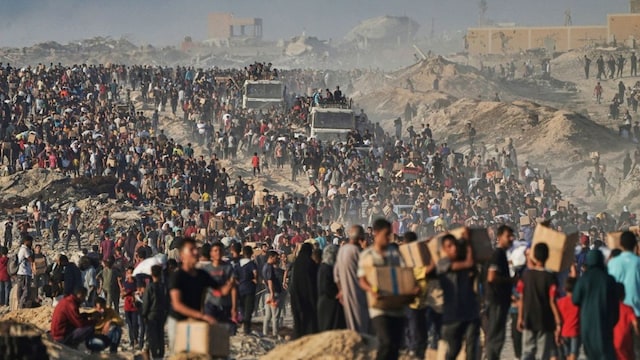 Palestinians carry food and humanitarian aid packages delivered by the Gaza Humanitarian Foundation in Rafah, southern Gaza Strip. (AP)