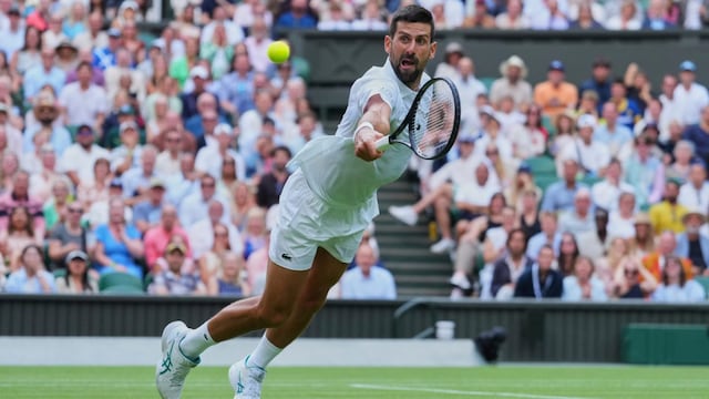 Novak Djokovic dives to return to Miomir Kecmanovic. (AP Photo)
