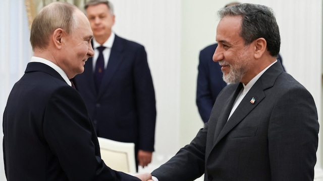 Russian President Vladimir Putin with Iranian Foreign Minister Abbas Araghchi. (Kremlin Pool Photo via AP)