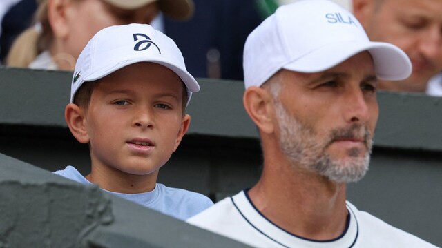 Novak Djokovic's son Stefan (left) is seen next to Serbian coach Dusan Vemic. (AFP Photo)