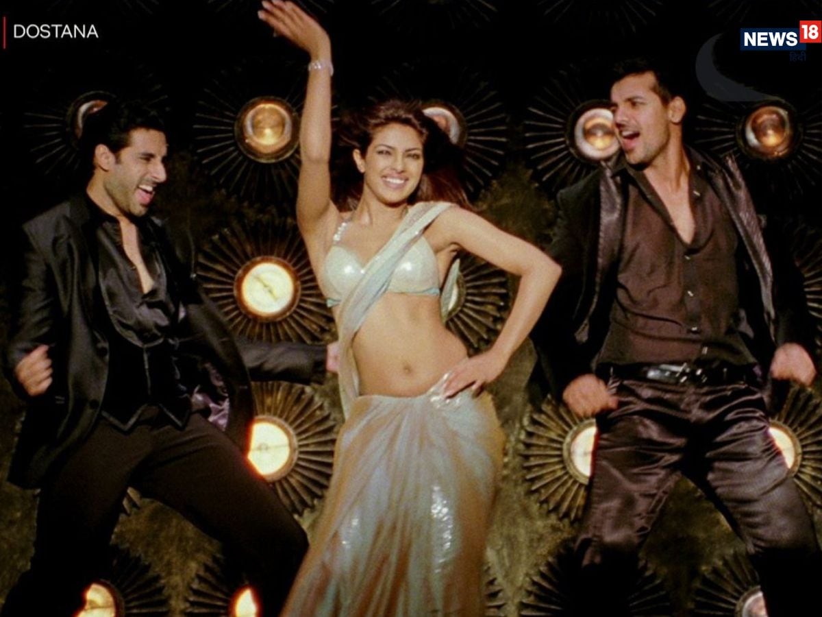 Priyanka Chopra redefined party fashion with her golden sequin saree in Dostana’s ‘Desi Girl’. The look became a global sensation, inspiring countless recreations at weddings, award shows, and red carpets, and firmly establishing the saree as a glamorous party outfit. (News18 Hindi) Priyanka Chopra redefined party fashion with her golden sequin saree in Dostana’s ‘Desi Girl’. The look became a global sensation, inspiring countless recreations at weddings, award shows, and red carpets, and firmly establishing the saree as a glamorous party outfit. (News18 Hindi)