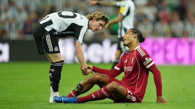 Anthony Gordon with Virgil van Dijk. (AP Photo)