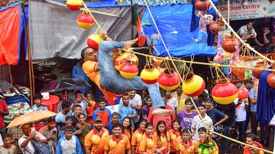 A govinda climbs a rope during Dahi Handi ceremony on the occasion of Janmashtami festival in Mumbai. (PTI photo)