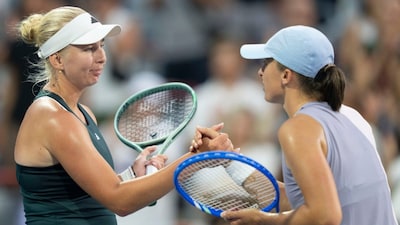 Clara Tauson (left) is congratulated by Iga Swiatek following their contest in Montreal. (AP Photo)