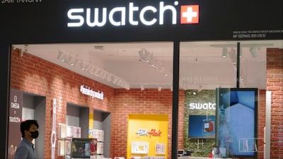 A man walk pass Swatch outlet at a shopping mall in Putrajaya, Malaysia (Photo: AP)