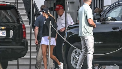 US President Donald Trump (R) and his granddaughter Kai Trump load the motorcade on the south lawn of the White House in Washington DC (AFP)