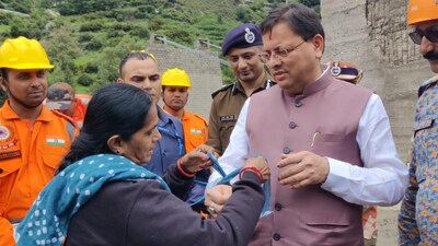 Dhangauri Barauliya, a resident of Ishanpur in Ahmedabad, tied the Rakhi to CM Dhami. (ANI)