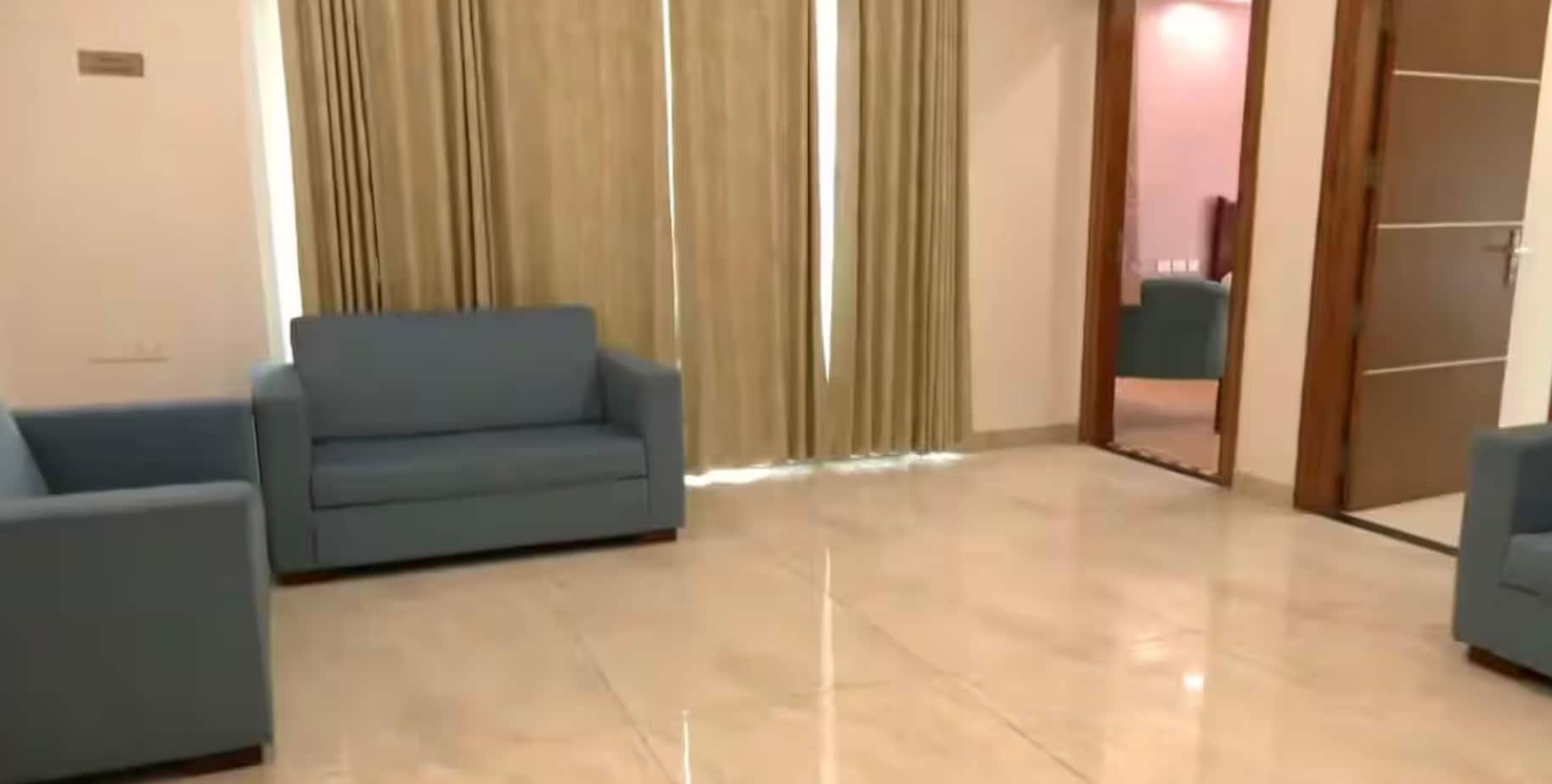 The interiors include a drawing and dining room, family lounge, puja room, and five bedrooms, each with an attached dressing area and en-suite bathroom. The kitchens are fully modular, fitted with cooking hobs, chimneys, and ample storage, while wardrobes in all rooms are modular as well. Two independent staff units — each with a kitchenette and attached bathroom — are integrated into the layout. The interiors include a drawing and dining room, family lounge, puja room, and five bedrooms, each with an attached dressing area and en-suite bathroom. The kitchens are fully modular, fitted with cooking hobs, chimneys, and ample storage, while wardrobes in all rooms are modular as well. Two independent staff units — each with a kitchenette and attached bathroom — are integrated into the layout.