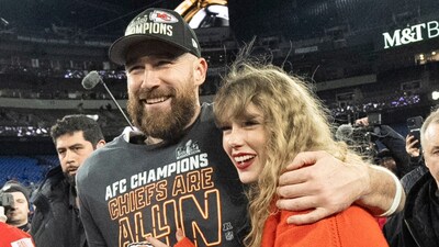 Travis Kelce (left) and Taylor Swift walk together after an AFC Championship NFL football game. (AP Photo)