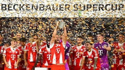 Bayern's Harry Kane celebrates with teammates after winning the German Supercup final soccer match between VfB Stuttgart and Bayern Munich in Stuttgart, Germany, Saturday, Aug. 16, 2025. (Tom Weller/dpa via AP)
