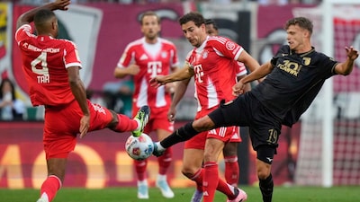 Bayern's Jonathan Tah, left, Bayern's Leon Goretzka, center, and Augsburg's Robin Fellhauer challenge for the ball during the Bundesliga soccer match between FC Augsburg and FC Bayern Munich in Augsburg, Germany, Aug. 30, 2025. (AP Photo/Matthias Schrader)
