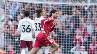 Liverpool's Dominik Szoboszlai runs to celebrate after scoring his sides first goal during the English Premier League soccer match between FC Liverpool and FC Arsenal in Liverpool, England, Sunday, Aug. 31, 2025. (AP Photo/Jon Super)
