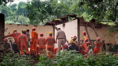 Security personnel at the site after a portion of the roof of a room at Dargah Sharif Patte Shah collapsed. (PTI photo)
