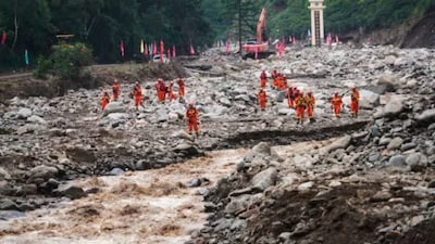 In this photo released by Xinhua News Agency, rescuers search for missing people at a village hit by mountain torrents following heavy downpour, in Yuzhong County of northwest China's Gansu Province. (AP)