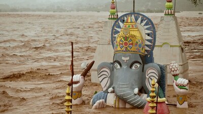 Water from the overflowing Tawi river floods a temple of Ganesh, the Hindu deity of prosperity, following heavy rain in Jammu on August 26. (Image: REUTERS/Mukesh Gupta)