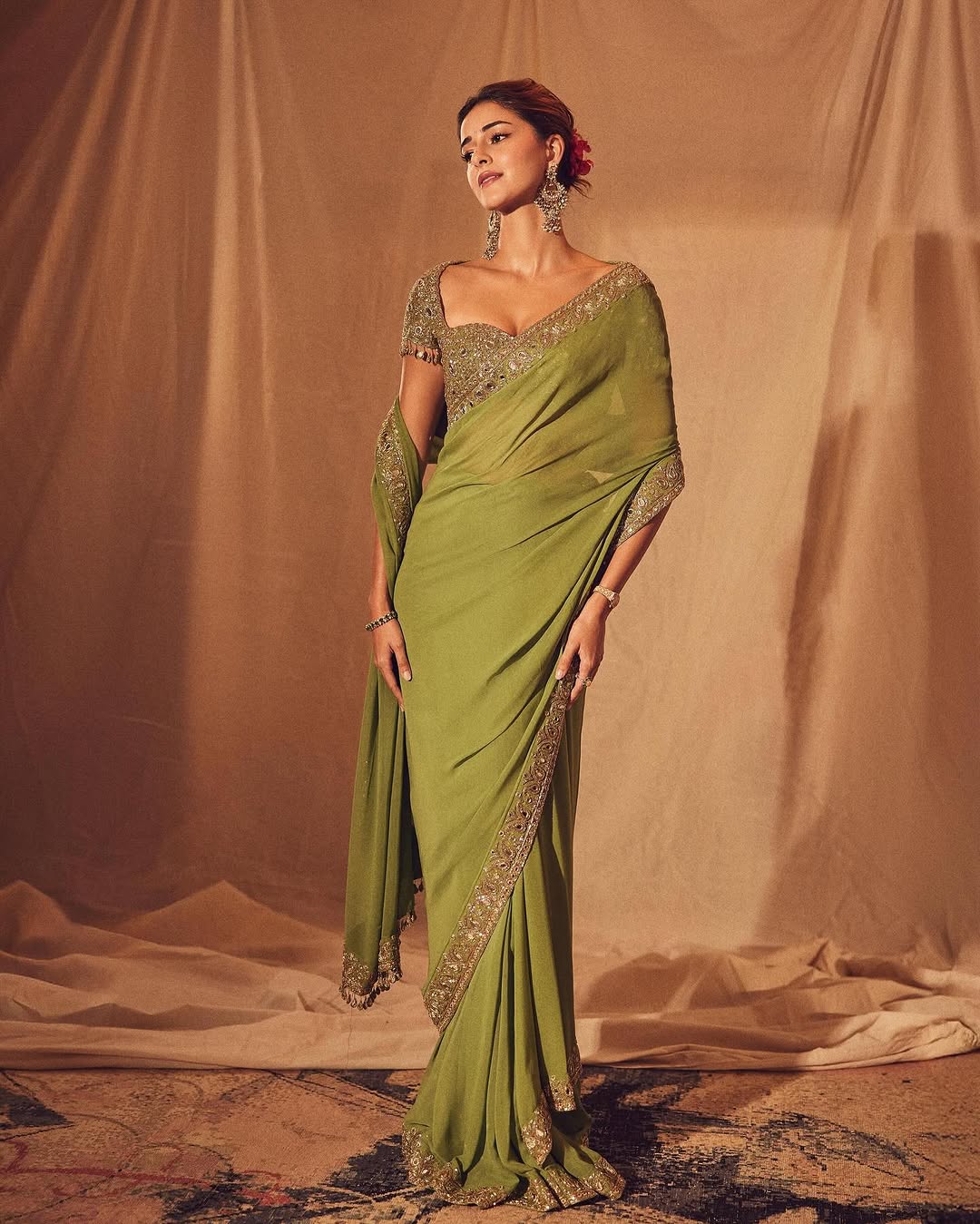 Ananya Panday: For Ganesh Chaturthi, the actress draped a warm olive classic saree set, which she paired with mirror tassel detailing on the sleeves. Ananya Panday: For Ganesh Chaturthi, the actress draped a warm olive classic saree set, which she paired with mirror tassel detailing on the sleeves.