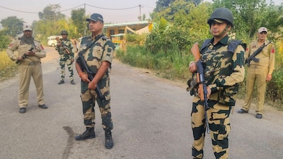 BSF and police personnel stand guard during a search and cordon operation after suspected movement of militants, in Saida Sukhal village in the Hiranagar sector of Kathua district. (PTI file photo)