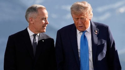 Canada's Prime Minister Mark Carney talks with President Donald Trump before a group photo at the G7 Summit. (AP file photo)